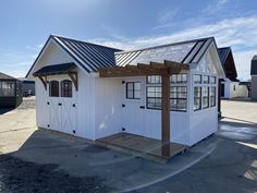 a small white building with a metal roof