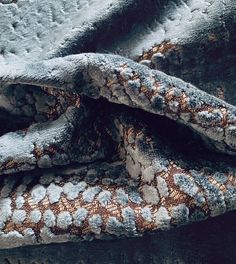 an up close shot of a blue and brown blanket