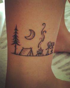 a woman's foot with a tattoo on it that has an image of people camping in the woods