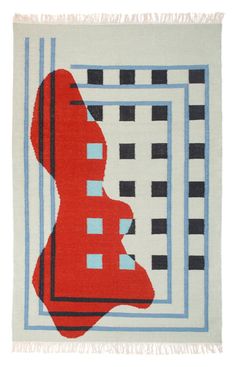 a red, black and white rug with blue squares in the center on a white background