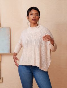 Whether you're headed to a coffee date, a casual evening entertaining friends, or a relaxed day at the office, this sweater effortlessly transitions between various outings. With a relaxed frame, sculptural neckline and fitted sleeves, you’ll be sure to move through your day with elegance and ease. This style is crafted in our latest recycled poly eco-yarn blend. BOXY MOCK NECK SWEATER IN MULTI-RIB EYELET PATTERN AND FITTED RIB SLEEVES Carmen is 5’7” wearing a size O/S 50% RECYCLED POLYESTER, 6% Chic Textured Knit Sweater With Funnel Neck, Chic Textured Knit Funnel Neck Sweater, Chic Funnel Neck Textured Sweater, Modern Relaxed Fit Sweater For Fall, Modern Sweater With Funnel Neck, Modern Textured Knit Tops For Fall, Modern Knit Top For Fall, Modern Knit Sweater For Fall, Modern Crew Neck Knit Top For Fall