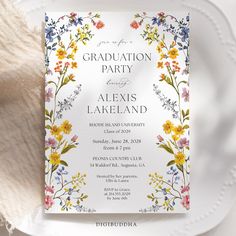 a white plate with a floral design on it and the words graduation party next to it