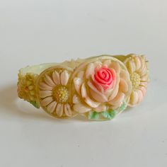 "Vintage children's bracelet. This is such a little charmer. The piece is a thin plastic feeling material. It has a textured, raised design. It has a floral theme. It does not have any maker marks or tags. It is like a cuff style but the ends touch. The colors are soft and pastel with a center burst of color in the largest flower in the center front of the piece. It measures: width at the widest point just shy of 1\". Across it measures about 2\" x 2\". It shows minor age and wear. Delicate piec Solid Silver Bracelets, Little Charmers, Vintage Veils, Art Nouveau Pendant, Floral Bracelet, Vintage Patches, Vintage California, Tacoma Wa, Floral Shoes