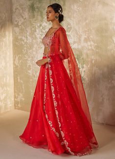 Unveil your inner elegance with the exquisite Red Embroidered Silk Organza Lehenga Set, a perfect blend of tradition and modernity. Crafted from pure silk organza, this ensemble features a red lehenga that exudes opulence through its all-over handwork motifs, adding a touch of luxury to every twirl. Paired with a delicately embroidered blouse, meticulously crafted with intricate aari handwork that showcases timeless artistry, the look is completed with a dupatta adorned with a heavily hand-embroidered border and motifs, elevating the ensemble to a new level of elegance. Perfect for a bride or bride-to-be on your special day, this outfit promises to make you the center of attention with its vibrant hue and breathtaking design. Composition : Dupatta & Lehenga - Pure Silk Organza, Blouse - Me Handwork Motifs, Organza Lehenga, Organza Blouse, Design Composition, Red Lehenga, Indian Wedding Wear, Embroidered Border, Silk Organza, Embroidered Silk