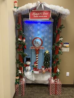 a door decorated for christmas with snowmen and candy canes