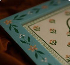 a close up view of a blue and white box with floral designs on it's sides