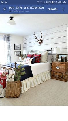 a bed room with a neatly made bed and two baskets