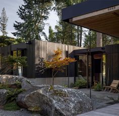 the house is surrounded by trees and rocks