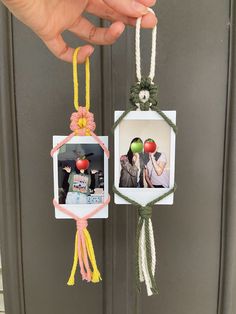 two pictures hanging from twine with rope attached to them, one has an apple and the other is a photo