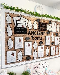 a bulletin board that has been decorated with pictures and writing on it, surrounded by greenery