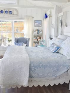 a bedroom with white walls and wooden floors