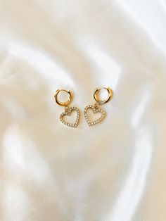 "Dainty Crystal CZ Huggie Hoop Earrings ❀❀ EARRING INFO: ❀❀ ➳ Huggie hoops are 201 stainless steel, with 316 surgical stainless steel pin ➳ Heart charm setting is gold plated brass ➳ Hoop size: 13.5mm ➳ Earring pin: 1mm ➳ Heart charm size: 15mm ❀❀ VIEW MORE EARRINGS: ❀❀ https://www.etsy.com/shop/bitsnpiecess/?section_id=23539584 ❀❀ RETURN POLICY: ❀❀ Please note that because of health/hygienic reasons, earrings cannot be returned or exchanged ❀❀ SHIPPING & PROCESSING: ❀❀ All products are MADE TO Gold Hoop Earrings With Heart Charm, Gold Open Heart Metal Earrings, Valentine's Day Tarnish Resistant Hoop Earrings, Tarnish Resistant Hoop Huggie Earrings For Valentine's Day, Gold Metal Hoop Earrings For Valentine's Day, Valentine's Day Tarnish Resistant Hoop Huggie Earrings, Metal Hoop Earrings With Heart Charm For Valentine's Day, Gold Hypoallergenic Open Heart Hoop Earrings, Small Gold Hoop Earrings With Heart Charm