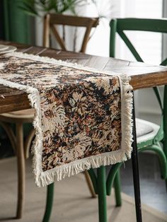 a table that has some chairs around it and a rug on top of the table