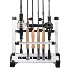 a fishing rod holder with five rods and two reels on the back, in front of