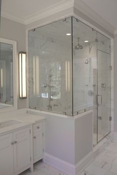 a large bathroom with a walk in shower next to a sink