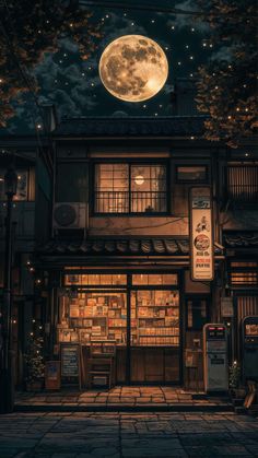 an old building with a full moon in the sky above it and lights shining on the windows