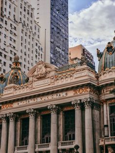 an old building in the middle of some tall buildings