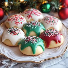 decorated cookies on a plate with christmas decorations in the background