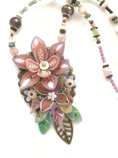 a necklace with flowers and beads on it