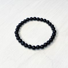 "This bracelet is 7\" (women's) in length. (I can size up or down 5 beads for same price (men's 8\")) Perfect accessorie alone or great for stacking. Black onyx beads are 6mm. Elastic is 1 mm finished with a glued triple knot.   Black Onyx meaning is Self control, decision making, intuition, protection. It is widely believed that black onyx can change your habits are erratic, either when used with faith. It is regarded as one powerful protection stone as it absorbs negative energy of people to release mental stress and promote emotional well-being.  Great gift idea for yourself or a friend. All bracelets will be packaged in an organza bag. I design and make everything myself. Each item is handcrafted and so please expect some minor differences from the photo shown. Colors may vary slightly Classic Onyx Beaded Bracelets With Adjustable Fit, Onyx Gemstone Beads Stretch Bracelet, Minimalist Onyx Beaded Bracelets With Round Beads, Round Onyx Stretch Bracelet With 8mm Beads, Adjustable Onyx Stretch Bracelet With Round Beads, Minimalist Onyx Beaded Bracelet With Round Beads, Minimalist Onyx Beaded Bracelet, Black Hypoallergenic Stretch Bracelet With Round Beads, Classic Onyx Bracelets With Round Beads