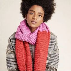 a woman with an afro wearing a pink and red scarf