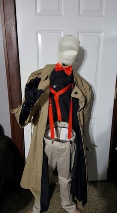 a mannequin is dressed up as a man in a trench coat