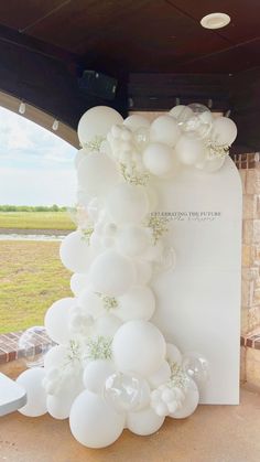 white balloons are hanging from the ceiling