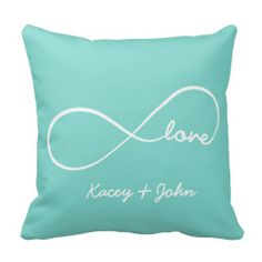 a blue pillow with the words love and a white heart on it's side