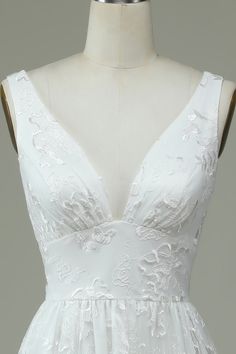 a white dress on a mannequin neckline, with an open back and lace detailing