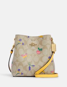 Signature coated canvas and smooth leatherCenter zip compartmentSnap closuresDetachable strap with 24" drop for shoulder or crossbody wear6 1/4" (L) x 6 1/4" (H) x 3" (W)Style No. C8255Color: Light Khaki Retro Yellow Designer Coach Bucket Shoulder Bag, Coach Town Bucket Bag, Yellow Coach Shoulder Bag, Coach Crossbody Bag Yellow, Coach Yellow Shoulder Bag With Gold-tone Hardware, Swag Bags, Retro Yellow, Vintage Leather Handbag, Leather Duffle Bag