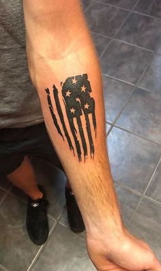 a man's arm with an american flag tattoo on it