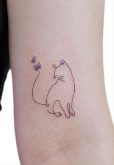 a cat and butterfly tattoo on the back of a woman's leg