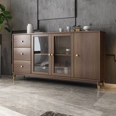 a large wooden cabinet with glass doors and drawers in a room that has grey walls