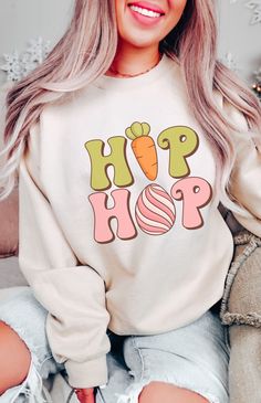 Super cute and comfy, this Easter Bunny Hip Hop Sweatshirt features a retro Easter Bunny graphic. With a cute Easter Bunny Easter Eggs graphic on the front and a cozy soft fleece interior, this Bunny Sweatshirt is sure to be a new fave. Available in Irish Green, Sand, Light Blue and Dark Heather colors. Fit is true to size, for oversized fit size up. Free Shipping USA. Be Cozy! Easter Bunny Hip Hop Sweatshirt 50% cotton, 50% polyester Medium-heavy fabric  Loose fit crewneck sweatshirt Machine wa Easter Sweatshirt Ideas, Easter Tshirt Designs, Easter Shirt Ideas, Easter Clothing, Easter Clothes, Hip Hop Easter, Easter Sweatshirt, Bunny Sweatshirt, Bunny Graphic