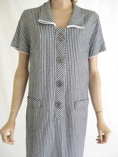 Fabulous vintage 40's day dress. Blue/ Gray and white pin striped. Lightweight seer sucker fabric. Awesome big buttons. In excellent vintage condition! Size: large. Please check the measurements provided to insure a good fit. Bust: waist: Hips: Length: Vintage Striped Workwear Dresses, Striped Retro Dresses With Buttons, Vintage Striped Dresses For Daywear, Retro Striped Dresses With Buttons, Vintage Cotton Shirt With Striped Collar, Vintage Short Sleeve Striped Dress, Vintage Collared Tops With Vertical Stripes, Vintage Striped Cotton T-shirt, Seer Sucker