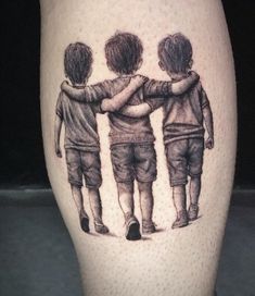 a tattoo on the leg of a person with three children standing in front of them