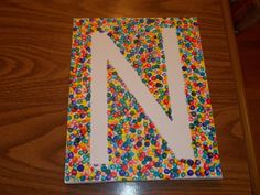 the letter n is made out of candy and sprinkles