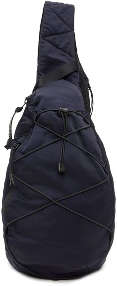 Water-resistant garment-dyed nylon sateen messenger bag in navy. · Webbing carry handle · Zip pocket at press-release crossbody strap · Logo-printed acetate lens · Zip pocket at face · Criss-crossing bungee-style drawstring · Padded mesh back face · Zip closure · Patch pockets and lanyard clasp at interior · Canvas lining · H13.5 x W10 x D3.5 Supplier color: Total eclipse Nylon Crossbody Backpack For Outdoor Activities, Navy Nylon Functional Shoulder Bag, Nylon Shoulder Bag With Adjustable Strap For Hiking, Functional Navy Shoulder Bag For Outdoor, Navy Functional Shoulder Bag For Outdoor, Adjustable Strap Nylon Shoulder Bag For Hiking, Functional Nylon Crossbody Backpack, Nylon Crossbody Backpack For Outdoor, Nylon Bag With Detachable Strap For Outdoor Activities