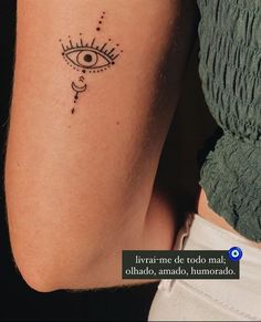 a woman's arm with an eye tattoo on the left side of her body