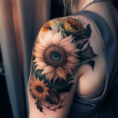 a woman's arm with sunflowers and leaves on it