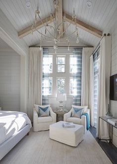 a living room filled with furniture and a flat screen tv on top of a wall