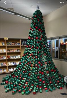 a very large christmas tree made out of books