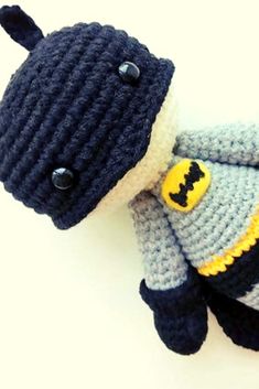 a crocheted stuffed animal wearing a batman costume