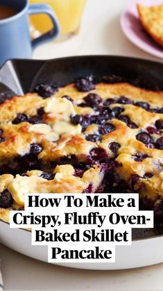 blueberry cobbler in a cast iron skillet with one slice cut from it