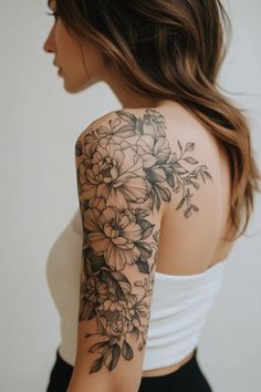 a woman's arm with flowers on it, and the back of her shoulder