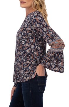 Long bell sleeves further the free-spirited flare of this chic top covered in a floral pasiley pattern. Notched neck Long sleeves 60% cotton, 40% modal Machine wash, tumble dry Imported Casual Boho Print Rayon Tops, Casual Rayon Tops With Boho Print, Fall Stretch Tops With Bell Sleeves, Floral Print Rayon Tops For Fall, Stretch Bell Sleeve Tops For Fall, Bohemian Floral Print Tops For Fall, Flowy Printed Tops For Fall, Fall Paisley Print Flowy Blouse, Flowy Floral Print Top For Fall