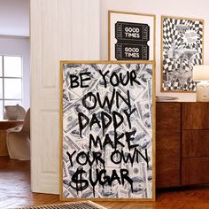 a poster with the words be your own paper make you own sugar on it in front of a wooden dresser