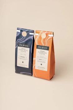 two bags of coffee sitting next to each other