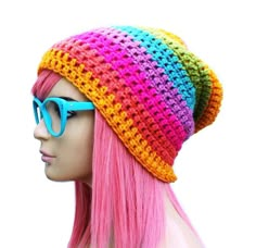 a mannequin with pink hair wearing sunglasses and a multicolored hat