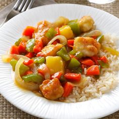 a white plate topped with rice and veggies